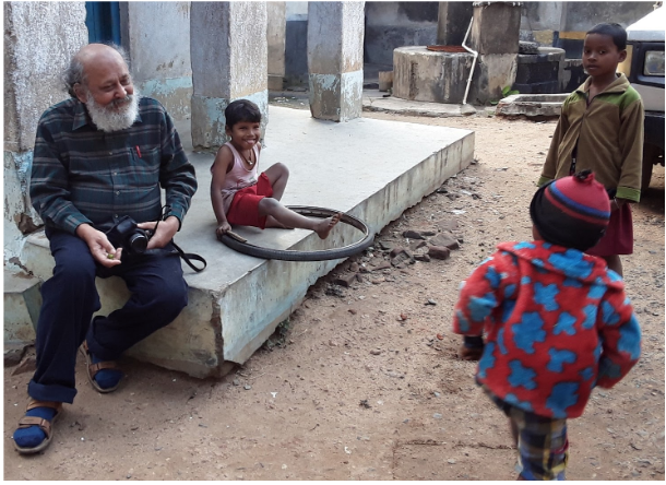 Ardhendu Chatterjee laughs with tribal kids in the village of Somenath Besra, West Bengal, India.